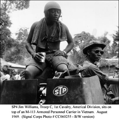 SP4 Jim Williams, Troop C, 1st Cavalry, Americal Division, sits on top of an M-113 Armored Personnel Carrier in Vietnam. August 1969. (Signal Corps Photo # CC060255 - B/W version)