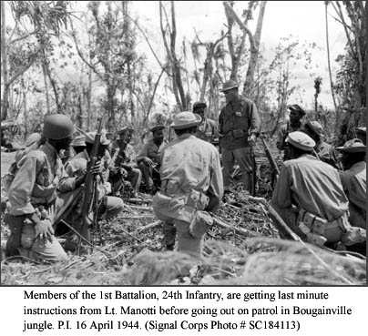 Members of the 1st Battalion, 24th Infantry, are getting last minute instructions from Lt. Manotti before going out on patrol in Bougainville jungle. P.I. 16 April 1944.