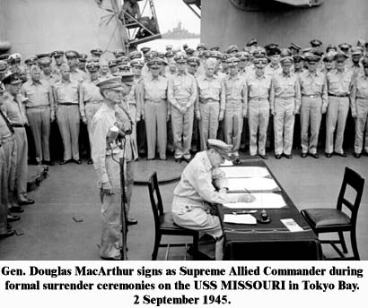 Photo, Gen Douglas MacArthur signs as Supreme Allied Commander during formal surrender ceremonies on the USS MISSOURI in Tokyo Bay. 2 September 1945.