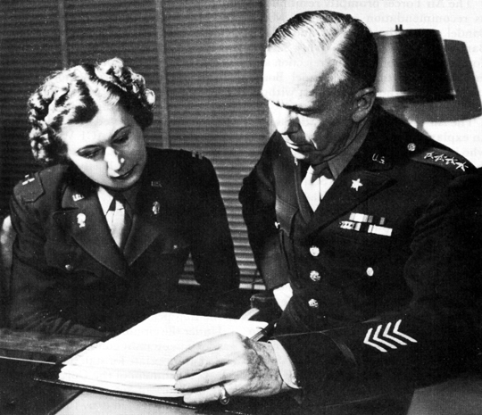 GENERAL MARSHALL confers with Capt. Florence T. Newsome in his office at the Pentagon.