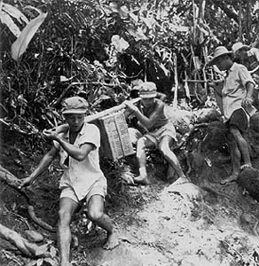 Filipino volunteers carry supplies into the mountains to reach 1st Cavalry Division troops