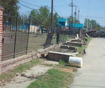 Photo: A collapsed fence around Jackson Barracks. Photograph courtesy of David Hanselman.