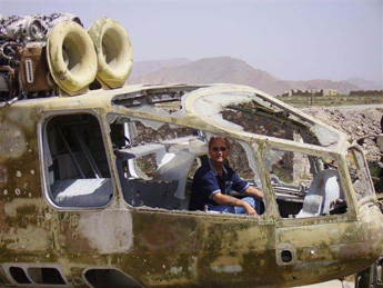 Photo: Raymond Lutz outside the museum in what is left of an old Soviet Hind helicopter.