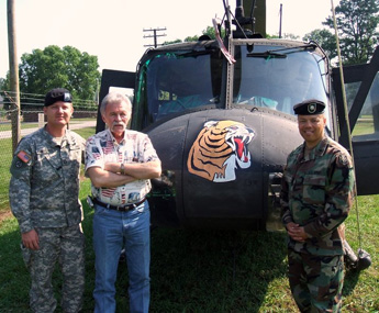 Photo: Capt. Dave Hanselman (left) and Lt. Col. Phil Govia (right) talk with John Bagosy in front of a UH–1H, number 852, the one on which he served as a gunner in Vietnam. All photographs courtesy of the museum staff.