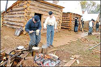 Photo: A Civil War winter cabin located on the Heritage Trail during a recent interpretive program. These cabins are only one of many different vignette exhibits of Army heritage through the ages. Others include the Hagerstown Pike at Antietam, the Omaha beachhead of Normandy, a French and Indian War blockhouse, a Revolutionary War earthwork, Vietnam-era, Spanish American War, World War I, etc.