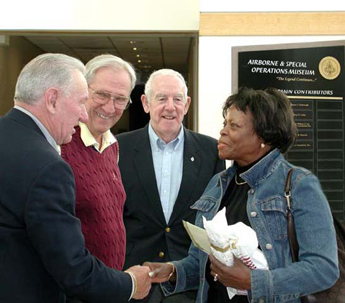 Photo: Willa McRae-Haley of Brooklyn, N.Y., is greeted by John Koenig, Henry Holt and retired Gen. Jim Lindsay at the Army's Airborne & Special Operations Museum in Fayetteville, N.C. McRae-Haley was the museum's one millionth visitor, 17 January 2006. Photo courtesy of Patrick Tremblay.