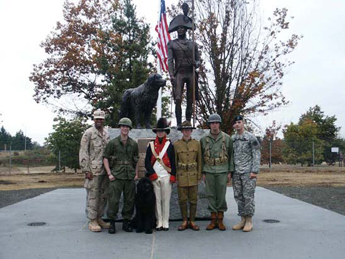 Photo: The Fort Lewis Color Guard and a Newfoundland dog pose with the new Captain Lewis and Seaman statues, 30 September 2005.