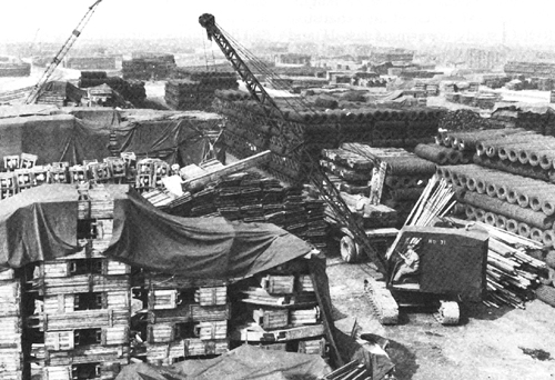 Photo:  Engineer crane stacks lumber at Thatcham, April 1944