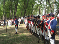 Photo:  Reenactors portray the garrison of the Belle Fontaine Cantonment, the first US Army installation west of the Mississippi River, preparing to greet the expedition on its September 1806 return.