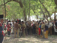 Photo:  Reenactors from the “Discovery Expedition of Saint Charles” portray the arrival of the Corps of Discovery, accompanied by representatives of American Indian nations, at the Belle Fontaine Cantonment.