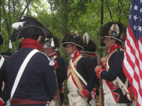 Photo:  Volunteer reenactors from the Army Corps of Engineers and Frontier Army Museum Living History Association portraying Soldiers from a detachment of the 1 st US Infantry Regiment and garrison of the Belle Fontaine Cantonment. 