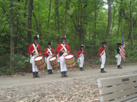 Photo:  Field Musicks standing at “attention.” Musicians, or “musicks,” in the armies of the Jefferson-era conveyed camp and maneuver signals by fife and drum, as well as provided martial music for marching, parades and ceremonies. 