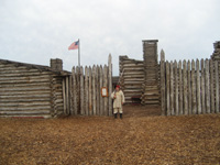 Photo:  A reenactor in Jeffersonian-era US Army fatigue uniform stands sentry duty at the gate of Camp River Du Bois. 
