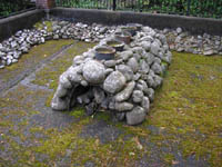 Photo: A view of the Salt Works employed by the Lewis and Clark expedition to boil seawater in order to obtain salt used to cure meat and for trading purposes with neighboring Native American tribes.  This kiln, which was reconstructed on the site of the original, is located in the present day town of Seaside, Oregon.  The stone kiln seen here is located about 30 minutes by automobile from Fort Clatsop, which translates to a trek of several days by the Lewis and Clark expedition.