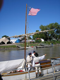 Photo: The American flag flies atop the mast of the White Pirogue moored at the mouth of the Bad River in Fort Pierre, South Dakota.  Lewis and Clark made it a point to display the United States flag during the expedition.  The United States was very concerned about British encroachment along the Northwestern Coast and Spanish expeditions making their way north from Mexico.  Thus, it was very important for Lewis to maintain the appearance of an officially sponsored military expedition for as long as their uniforms lasted in order to provide a firm legal foundation against any European nation claiming sovereignty over the Pacific Northwest by virtue of exploration carried out by commercial entities seeking to expand the fur trade.