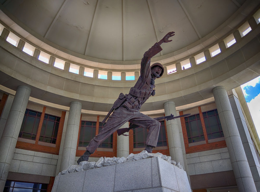 A statue of a Soldier in a circular room with a dome roof.