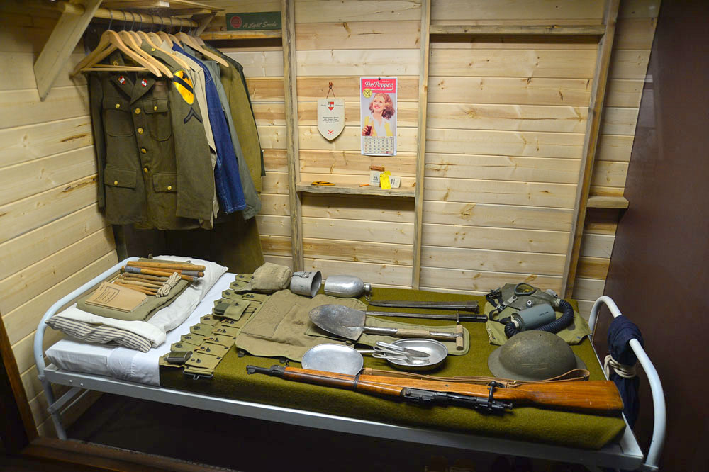 Exhibit featuring a bunk with Army clothing and supplies organized on top inside the Noncommissioned Officer Heritage & Education Center.