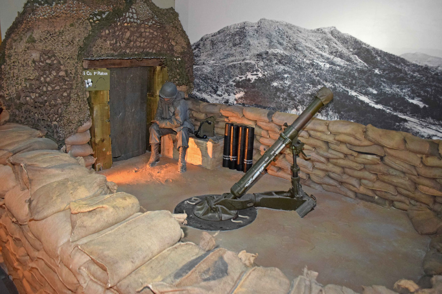 Museum display of a Soldier sitting.