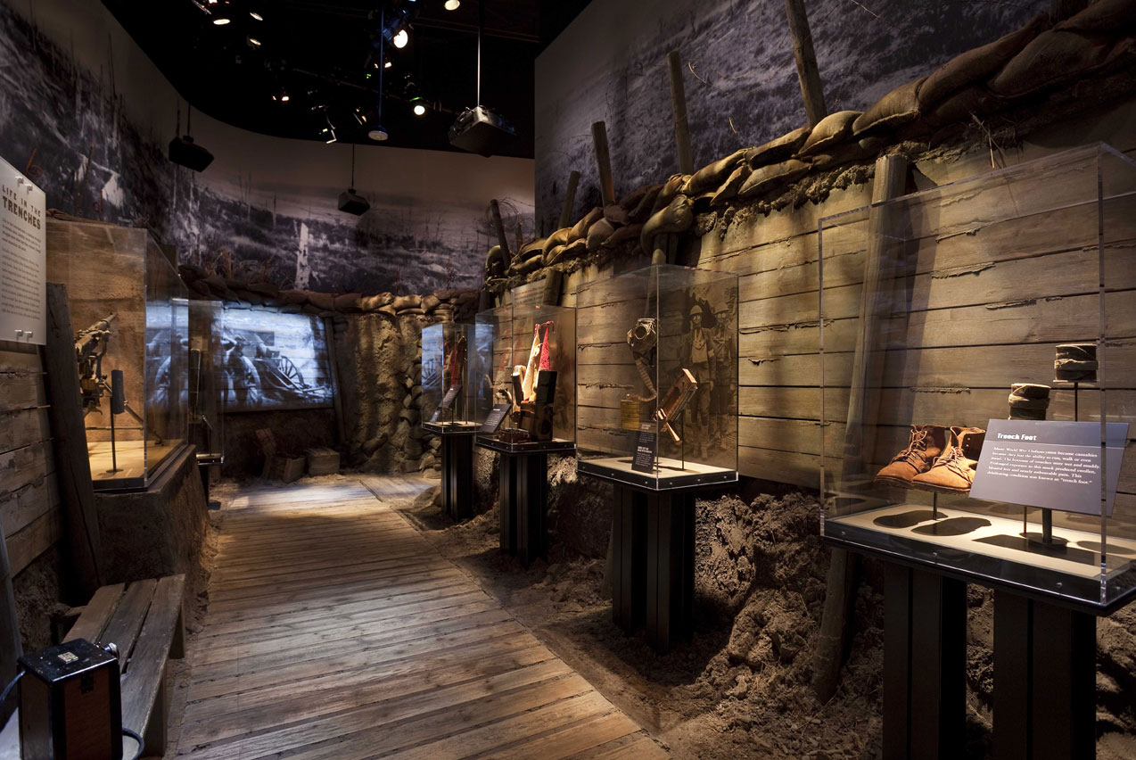 Several small window displays in museum room with wooden floor.