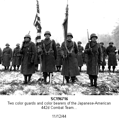 SC196716.  Two color guards and two color bearers of the Japanese-American 442d Combat Team, stand at attention, while their citations are read. They are standing on ground in the Bruyeres area, France, where many of their comrades fell.  11/12/44