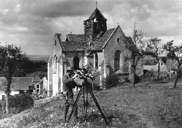 Photo:  Signal Corps photographer operates a camouflaged camera in France