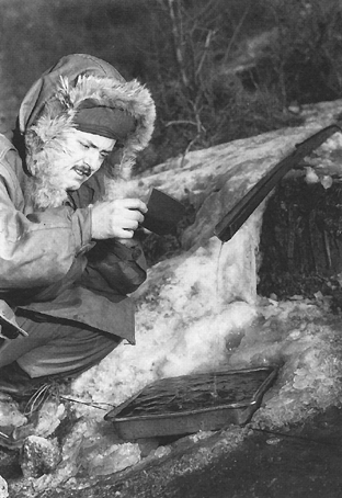 Photo:  A member of the 40th Signal Company washes negatives in an icy Korean mountain stream
