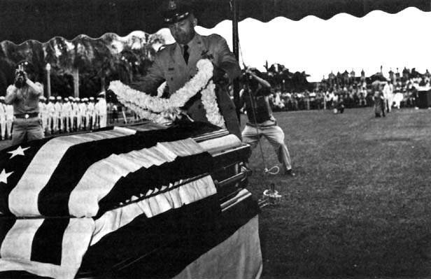 Photo: Colonel Eggleston designates choice by placing lei on one casket.