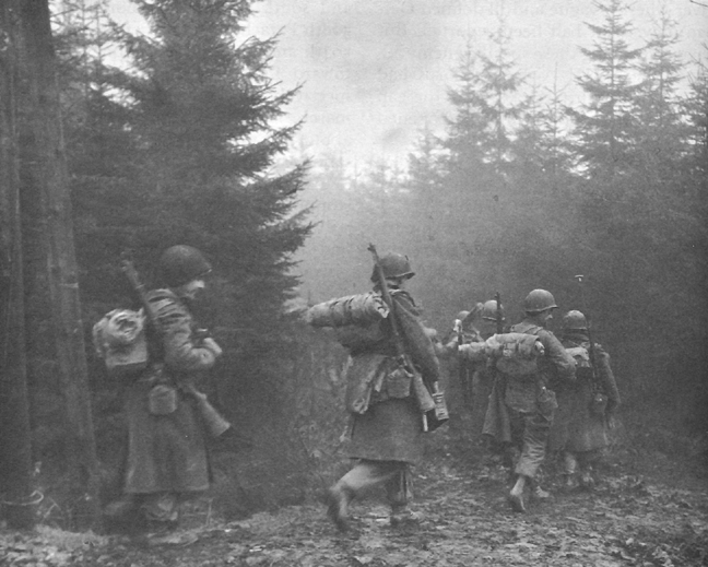 Photo:  Troops of 325th Glider Infantry moving through fog to a new position