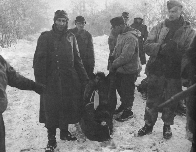 Photo:  German prisoners carrying one of their wounded in a blanket