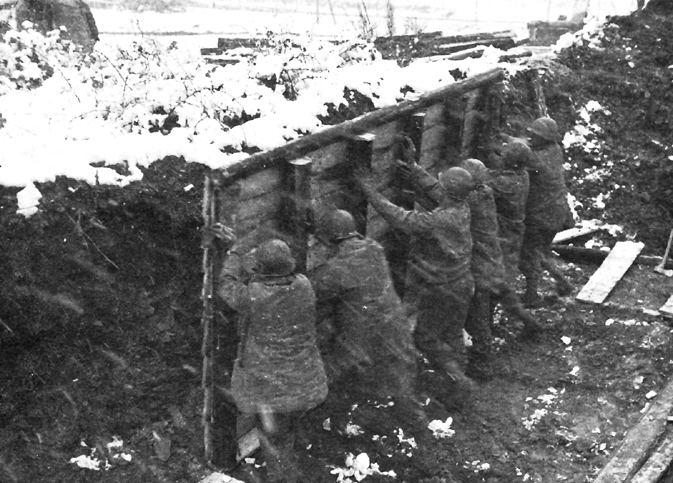 Photo:  Constructing a winterized squad hut near the front lines.