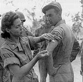 U.S. Army nurse instructs Army medics on the proper method of giving an injection, Queensland, Australia, 1942.