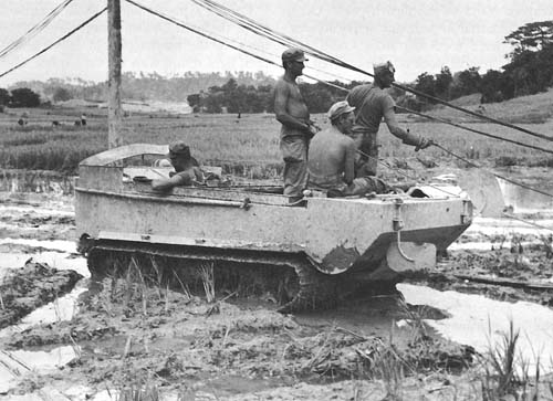 Photo:  Signal Corps men in a Weasel, Okinawa