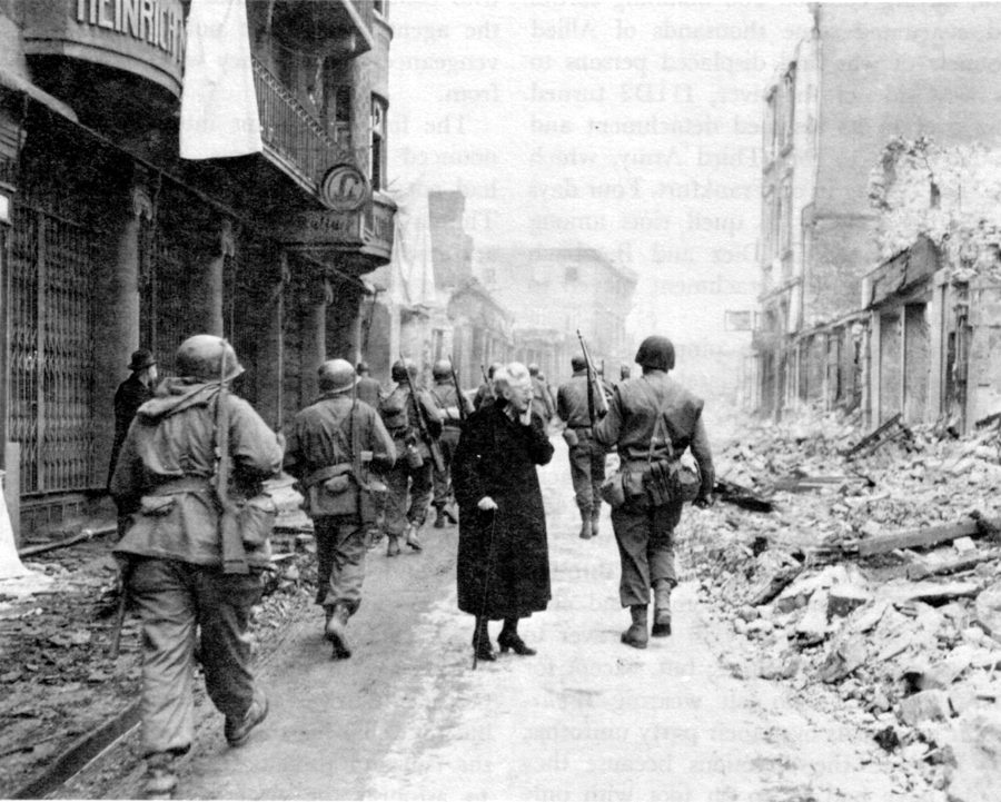 IN THE WAKE OF BATTLE a German woman surveys the wreckage of her property.
