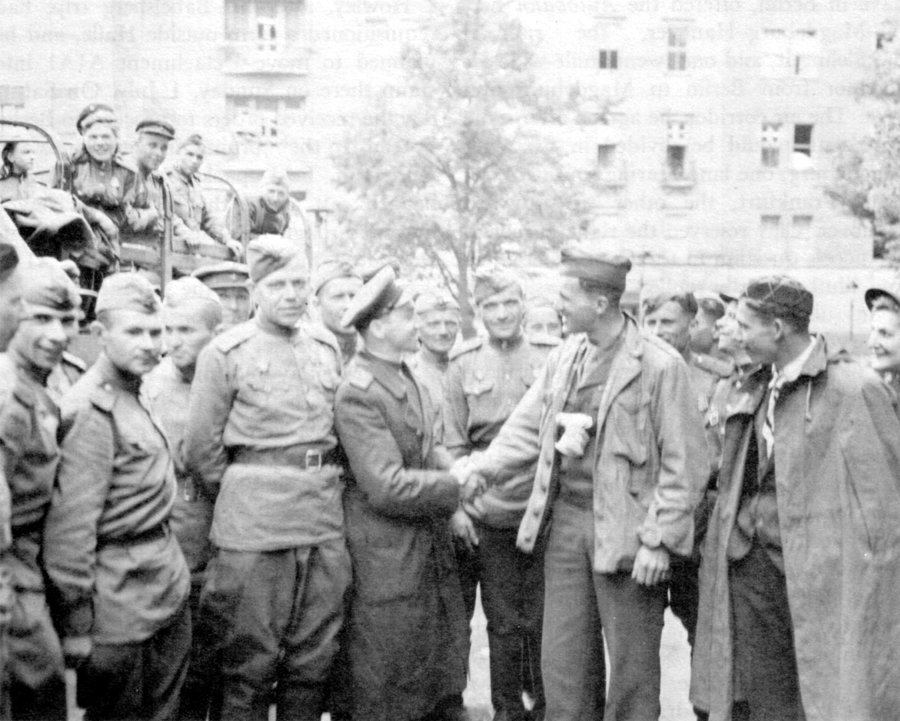 ALLIES MEET IN BERLIN. Soviet troops greet Signal Corps photographer who was one o f the first Americans into the city on 4 July 1945.