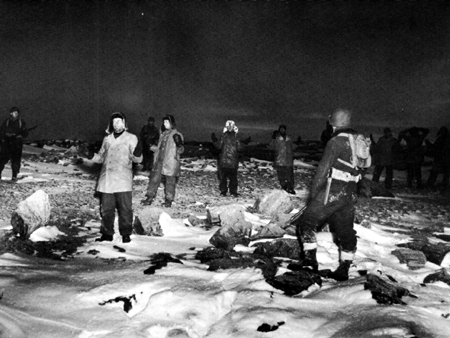 Photo: COAST GUARDSMEN CAPTURE TWELVE GERMANS in a raid on the last enemy weather-radio station in Greenland.