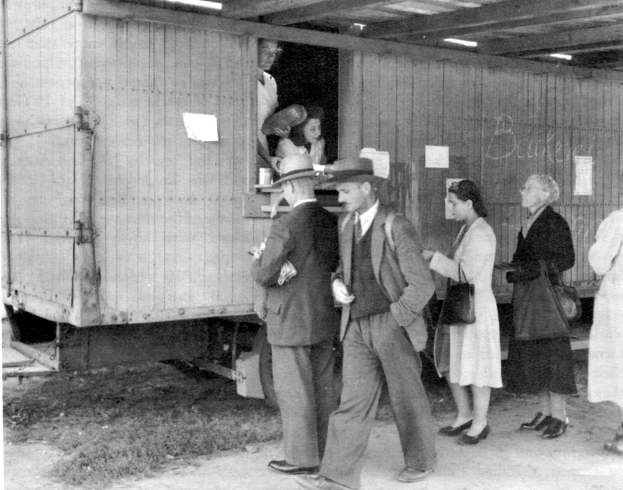 BERLINERS RECEIVE BREAD RATION FROM A TRAILER because there is no transportation to business areas.