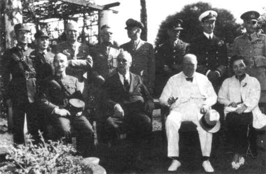 GENERALISSIMO CHIANG KAI-SHEK AND MADAME CHIANG seated with President Roosevelt and Prime Minister Churchill at the Cairo conference. Standing from deft: General Shang Chen, Lt. Gen. Lin Wei, Generals Somervell, Stilwell, arid Arnold., Sir John Dill, Lord Louis Mountbatten, and Lt. Gen. Sir Adrian Carton de Wiart. 