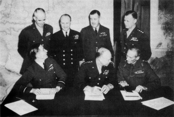 SUPREME COMMANDER, ALLIED EXPEDITIONARY FORCE, and his principal subordinates, London, r February zg.l. Seated from left: Air Chief Marshal Sir Arthur W. Tedder, General Eisenhower, General Sir Bernard L. Montgomery. Standing from left: Lt. Gen. Omar N. Bradley, Admiral Sir Bertram Ramsey, Air Marshal Sir Trafford Leigh-Mallory, and Lt. Gen. Walter Bedell Smith. Missing from the group is Lt. Gen. Carl A. Spaatz.