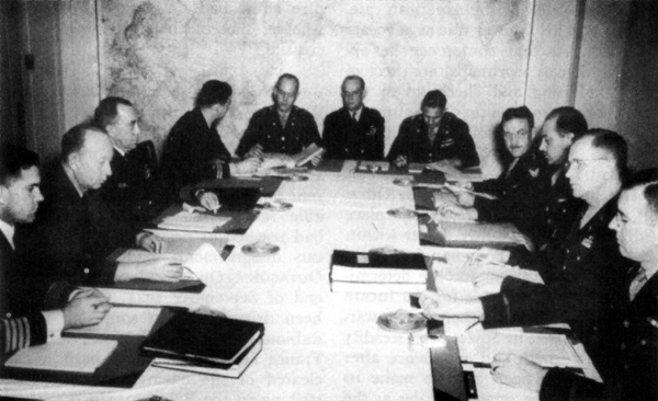 MEMBERS OF JOINT PLANNING STAFF AT OCTAGON. Around the table from left: Capt.. Paul D. Stroop, Rear Adm. Donald B. Duncan, Capt. James Fife, Lt. D. lWl. Gribbon, Brig. Gen. William W. Bessell, Jr., Cast. E. W. Burrough, Brig. Gen. Frank F. Everest, Brig. Gen. Joe L. Loutxenheiser, Brig. Gen. Richard G. Lindsay, Brig. Gen. Frank N. Roberts, and Cot. George A. Lincoln.