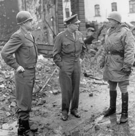 Left to right: Lt. Gen. Omar N. Bradley, Gen Dwight D. Eisenhower, and Lt. Gen. George S. Patton, Jr.