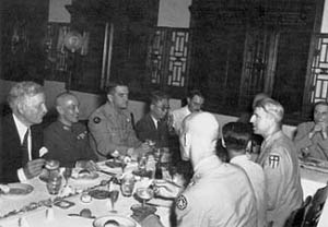 Photograph, At a banquet to honor General Chennault are, from left facing: Ambassador Hurley, Generalissimo Chang, General Chennault. General Wedemeyer is in profile at extreme right.
