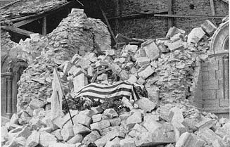 Photo, The flag-drapped coffin of Maj. Thomas Howie rests on the rubble of the cathedral in St. Lo.
