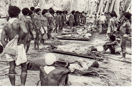 American and Australian casualties, with Papuan litter bearers.
