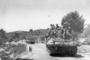 Troops and tank destroyers move inland.