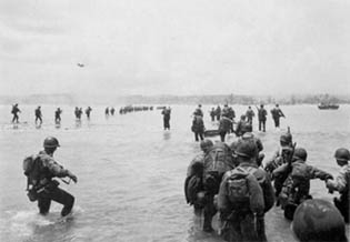 U.S. reinforcements wade ashore from LSTs off Saipan.
