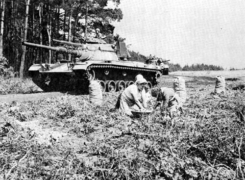 Photo: M60 Main Battle Tanks maneuver through a German farm during an exercise.