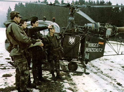Photo: A German Federal Border Guard aircrew consult with a 2d Armored Cavalry Regiment border patrol. March 1983.