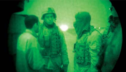 Discussion with an informant on a nighttime raid. Toward the end we wouldn't do raids unless we had talked to the informant ourselves, and most of the time we brought him along.