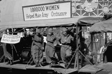 Women who worked in factories helping to make Army ordnance are featured in parade celebrating Armistice Day