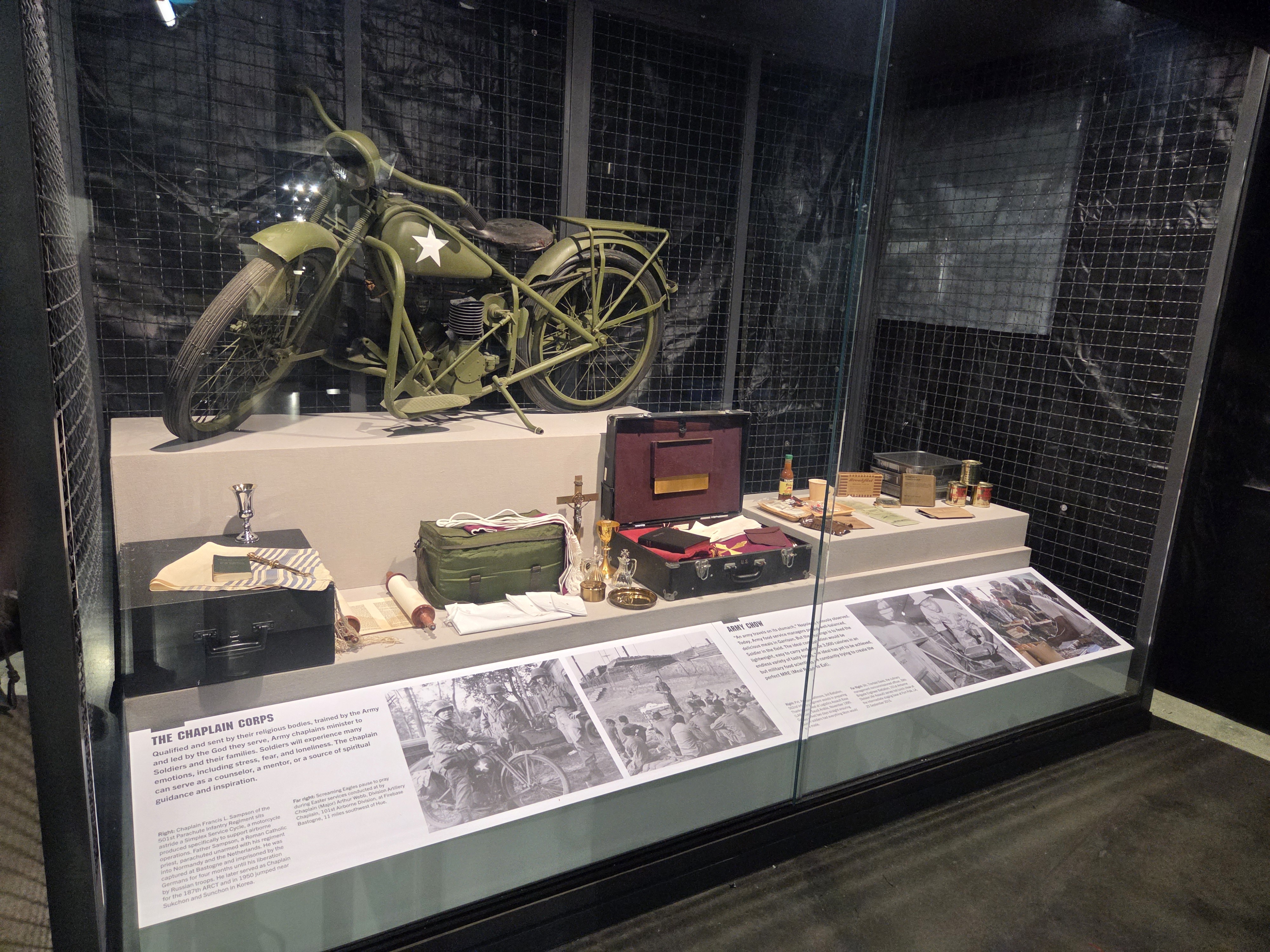Display case featuring a World War II-era U.S. Army motorcycle and Chaplain Corps artifacts at the Tennessee Wings of Liberty Museum.